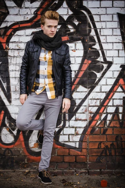 Fashion male portrait on graffiti wall — Stock Photo, Image