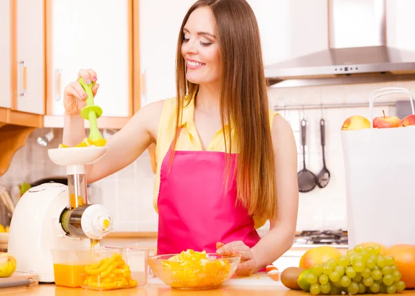 Mulher fazendo suco de laranja na máquina do juicer — Fotografia de Stock