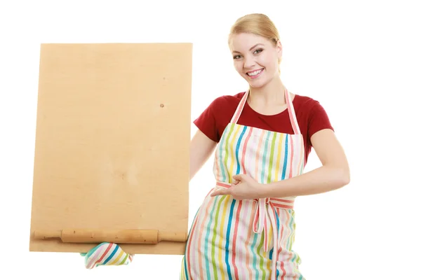 Housewife holds wooden board with copy space — Stock Photo, Image