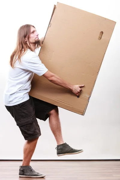 Delivery man holding a paper box. — Stock Photo, Image