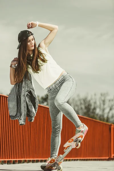 Teenage girl skater riding skateboard on street. — Stock Photo, Image