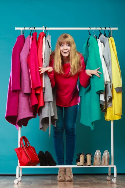 Woman choosing clothes to wear in mall or wardrobe — Stock Photo, Image