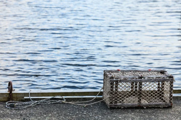 Crab cage in harbor on shore — Stock Photo, Image