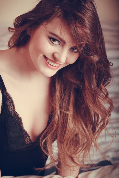 Portrait of happy young woman in lingerie in bed. — Stock Photo, Image