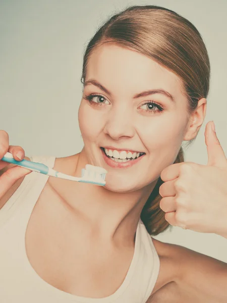 Woman holds toothbrush with toothpaste cleaning teeth — Stock Photo, Image