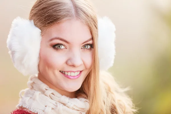 Portrait of pretty smiling woman in fur earmuffs. — Stock Photo, Image
