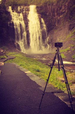 Camera and Skjervsfossen Waterfall, Norway clipart