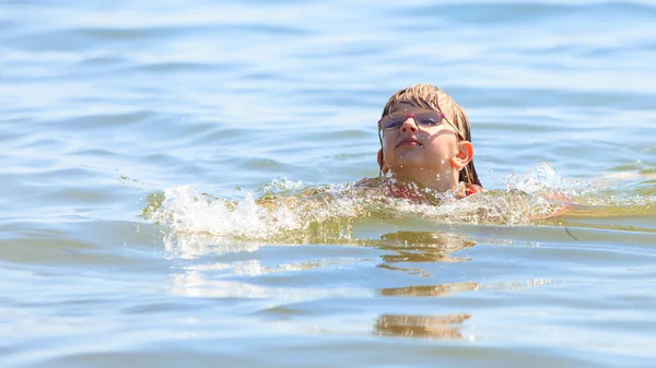 Маленька дівчинка плаває у морській воді. Веселощі — стокове фото