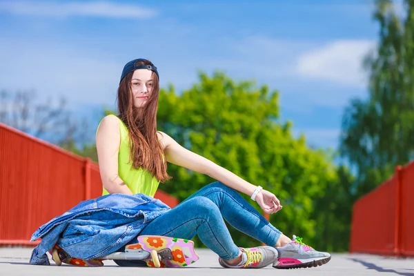 Teenage girl skater riding skateboard on street. — Stock Photo, Image