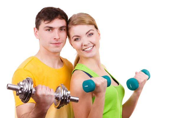 Couple exercising with dumbbells lifting weights Royalty Free Stock Images