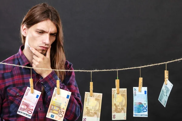Mies tarkistaa rahaa käteisellä — kuvapankkivalokuva
