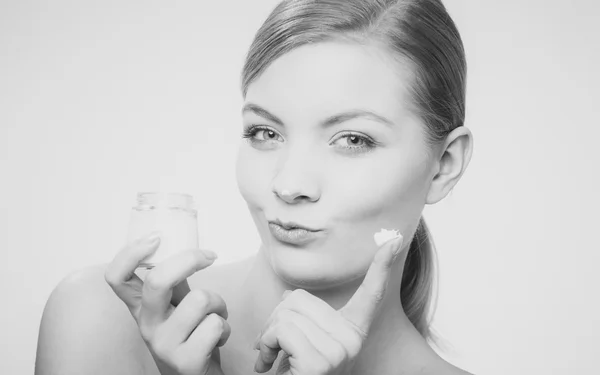 Woman applying cream on her skin face. — Stock Photo, Image