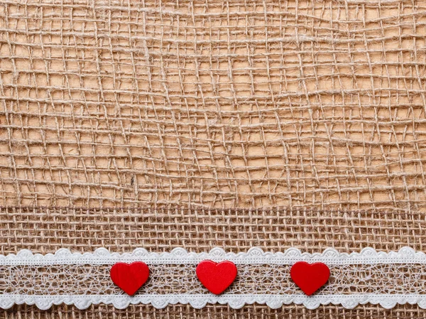 Red hearts on abstract cloth background — Stock Photo, Image