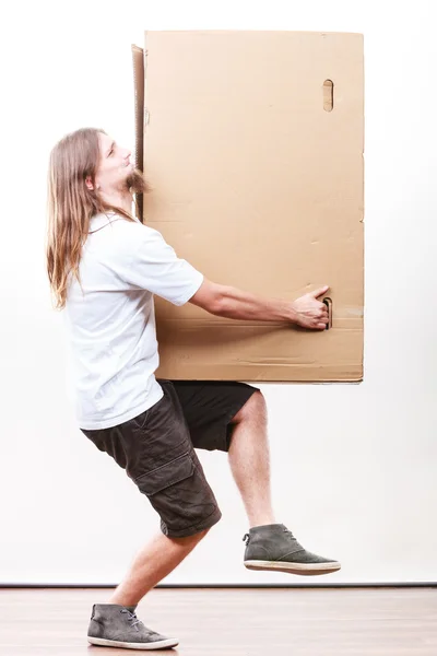 Delivery man holding a paper box. — Stock Photo, Image