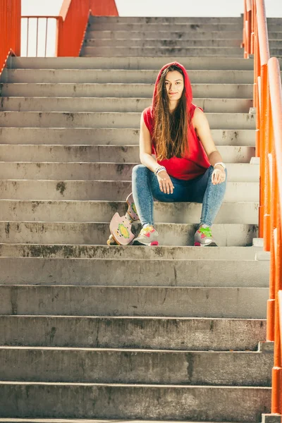 Chica de skate en las escaleras con monopatín . — Foto de Stock