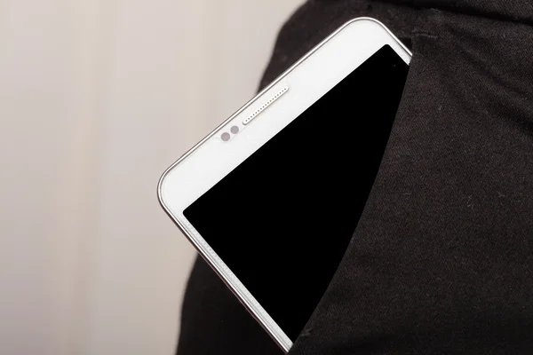 Mobilní telefon v kapse zobrazeno kalhoty. — Stock fotografie