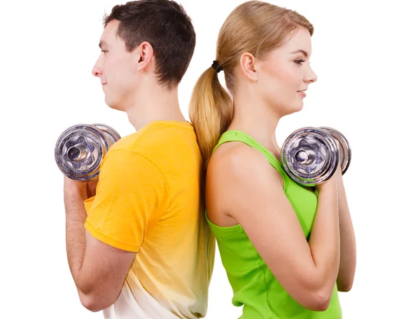 Couple exercising with dumbbells lifting weights — Stock Photo, Image