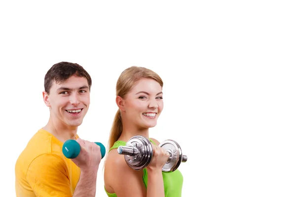 Couple exercising with dumbbells lifting weights — Stock Photo, Image