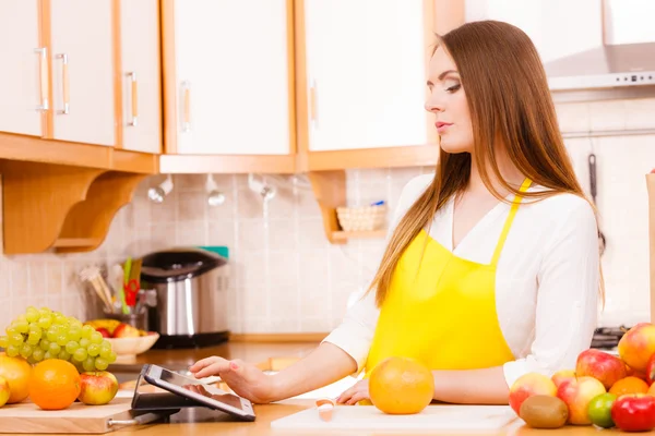 Mujer ama de casa en la cocina usando tableta — Foto de Stock