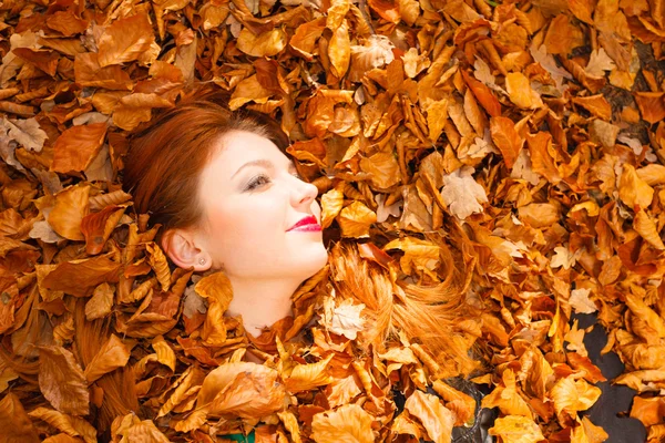 Woman face in autumn scenery — Stock fotografie