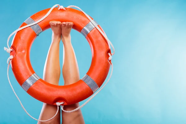 Life buoy ring on female legs — Stock Photo, Image