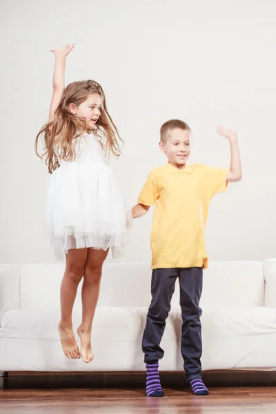 Happy cute kids little girl and boy jumping. — Stock Photo, Image