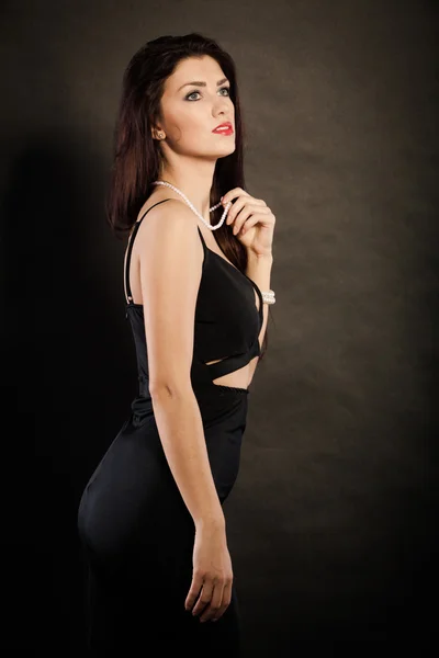 Woman in sensual black dress on dark — Stock Photo, Image