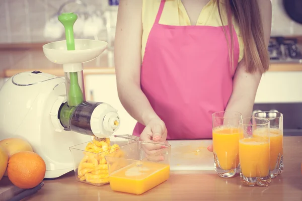 Femme versant boisson de jus d'orange dans le verre — Photo