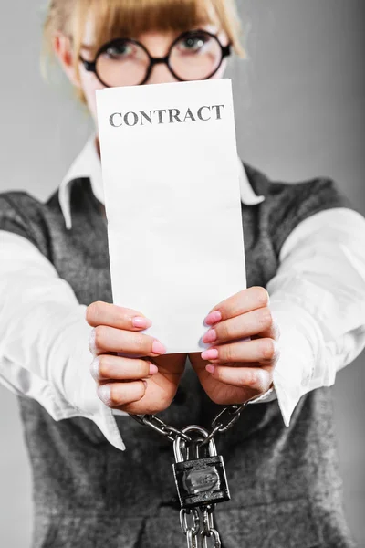 Businesswoman with chained hands holding contract — Stock Photo, Image