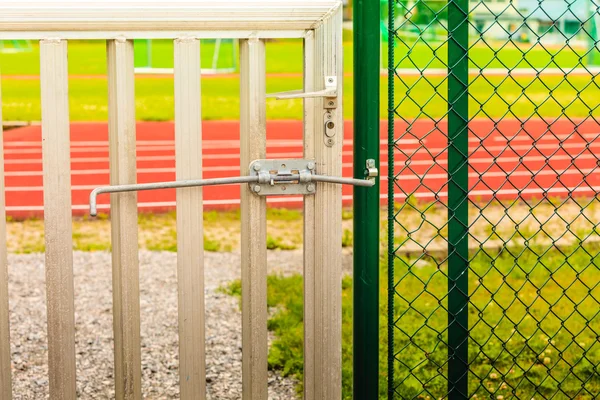 Padlock locked on stadium gate — Stock Photo, Image