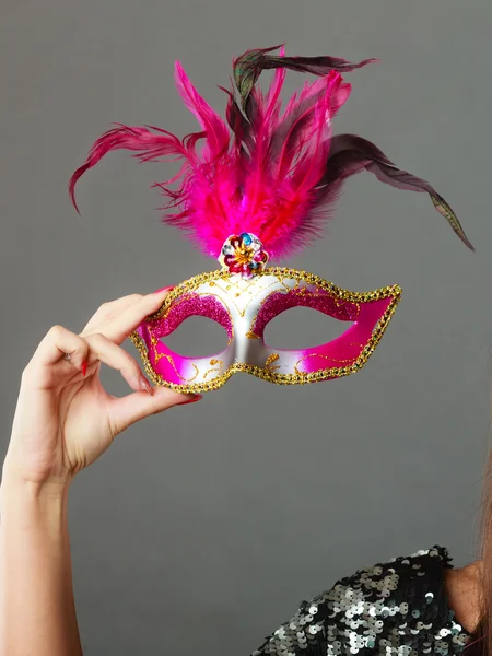 Woman hand holds carnival mask — 图库照片