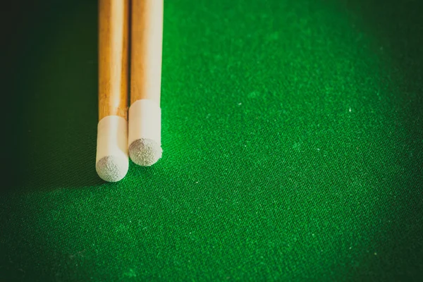 Cue sticks on green billiard table — Stock Photo, Image