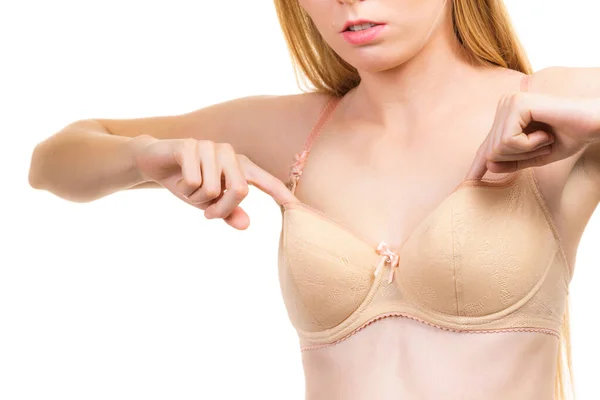 Young Slim Woman Holding Bra Strap. Straps Keep Falling Down