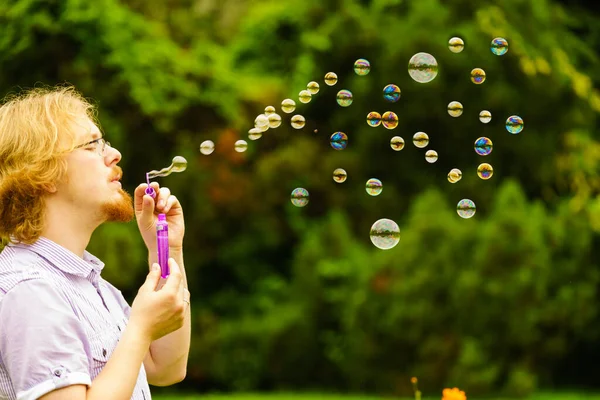 Happy Young Adult Man Blowing Soap Bubbles Nature Green Spring — Stock Photo, Image