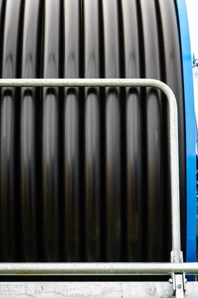 用软管卷筒灌水 卷起黑色橡胶软管 工业细节 — 图库照片