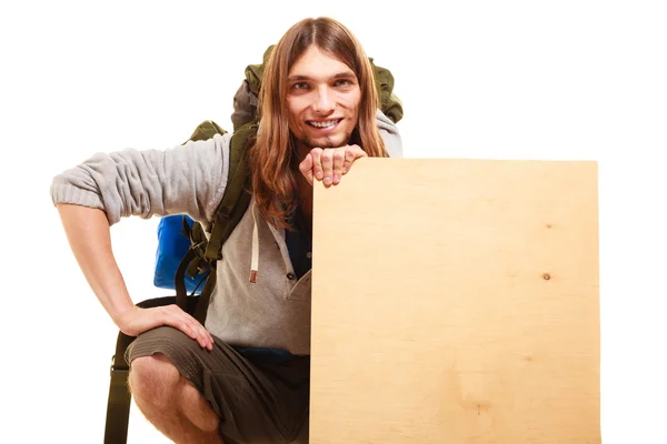 Male hiker with backpack and blank sign isolated — Stock Photo, Image