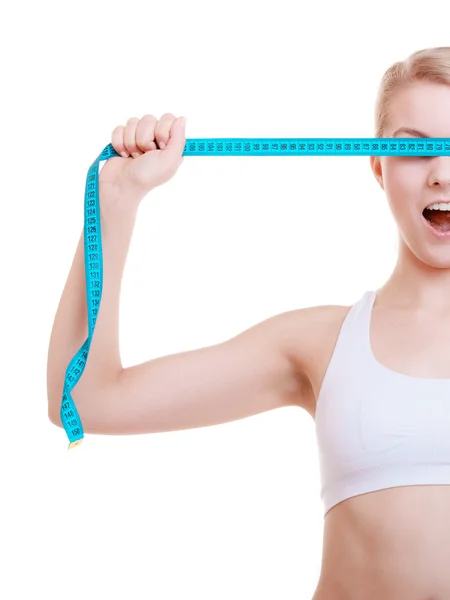 Fitness sporty girl covering her eyes with measuring tape isolated — Stock Photo, Image