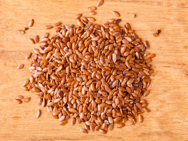 Healthy diet. Heap of flax seeds linseed on wooden background — Stock Photo, Image