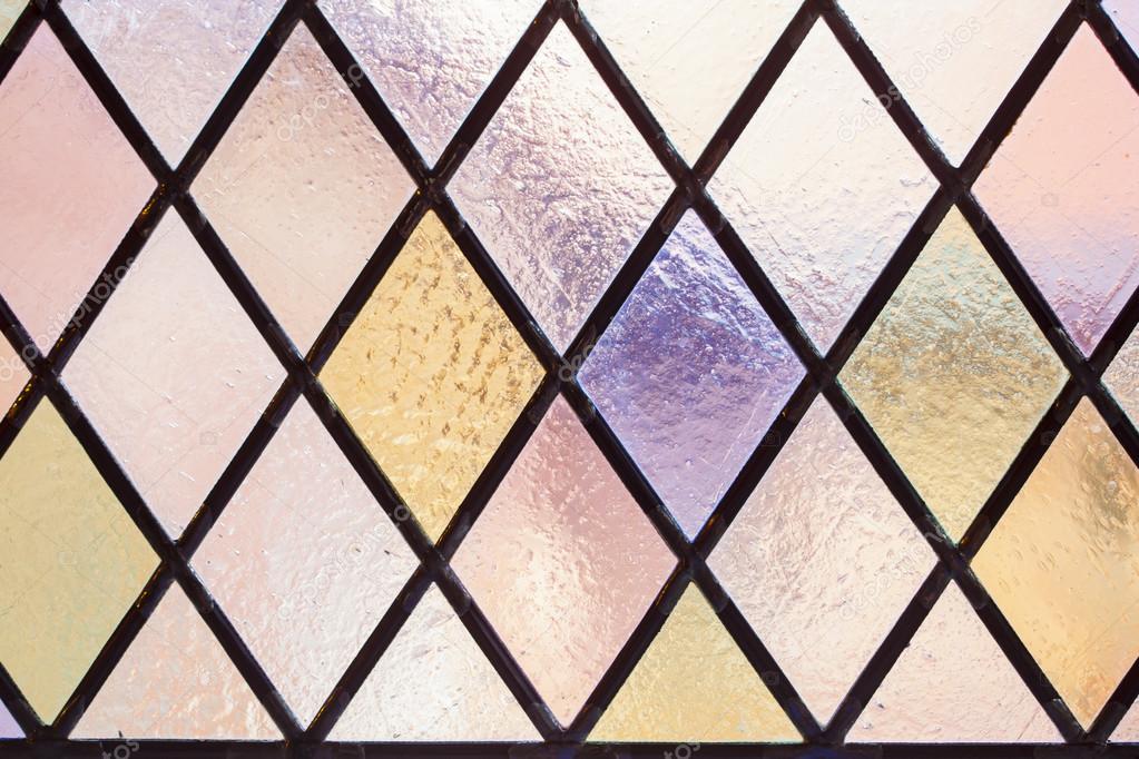 Stained glass with multi colored diamond pattern as background — Stock