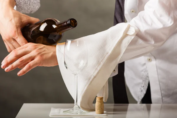 Man waiter pouring wine into glass. — Stock Photo, Image