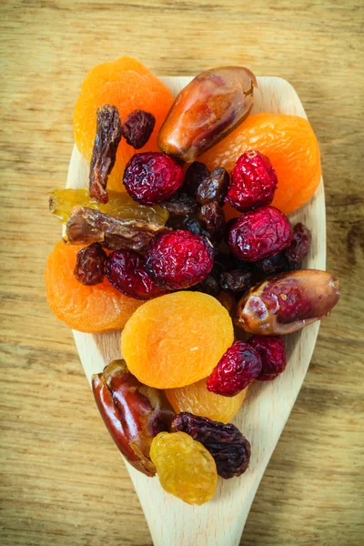 Varieties of dried fruits on wooden spoon. — Stock Photo, Image