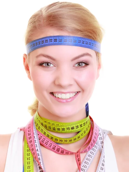 Obsessed fitness woman with a lot of colorful measure tapes — Stock Photo, Image