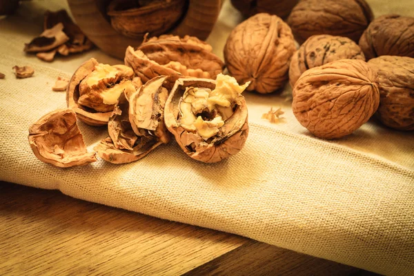 Walnut with nutcracker on rustic table — Stock Photo, Image