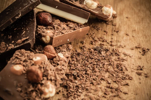 Different sorts chocolate and shavings. — Stock Photo, Image