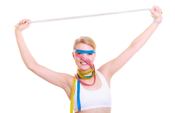 Obsessed fitness woman with a lot of colorful measure tapes — Stock Photo, Image