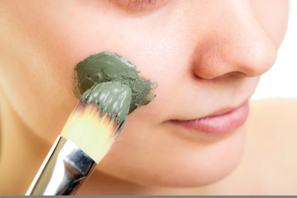 Cura della pelle. Donna che applica maschera di fango argilla sul viso. — Foto Stock