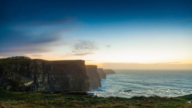 Cliffs of Moher at sunset in Co. Clare Ireland Europe. clipart
