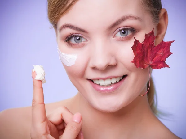 Skin care. Face of young woman girl with red maple leaf. — Stock Photo, Image