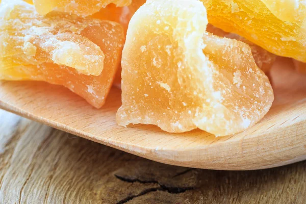 Closeup candied ginger on wooden spoon — Stock Photo, Image