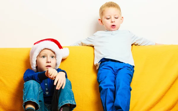 Niño en sombrero de santa rojo con su hermano en casa — Foto de Stock